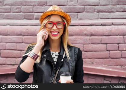 Attractive tourist see city . Young pretty girl tourist walking on street and talking on mobile phone