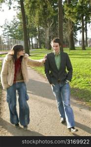 Attractive Urban Couple Walking Together In A City Park