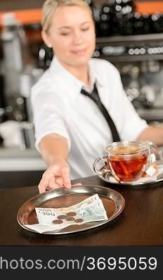 Attractive waitress taking tip in bar from tray czech crowns