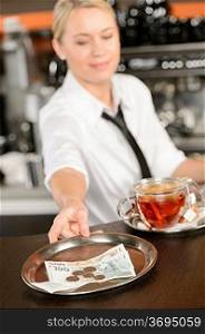 Attractive waitress taking tip in bar from tray czech crowns