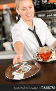 Attractive waitress taking tip in bar from tray euro