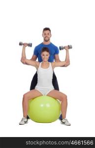 Attractive woman and a personal trainer with weight training
