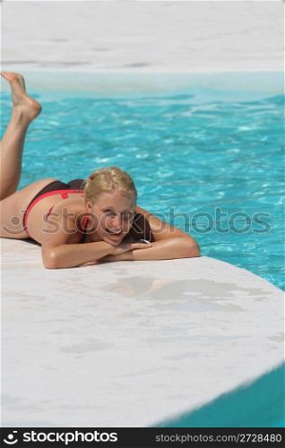Attractive woman at the Edge of a Swimming Pool