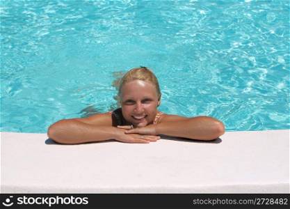 Attractive woman at the Edge of a Swimming Pool