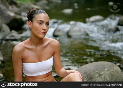 Attractive woman bathing by the river