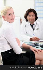 Attractive woman consulting with her doctor