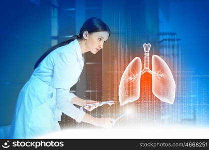 Attractive woman doctor. Image of pretty woman therapist examining virtual image of lungs