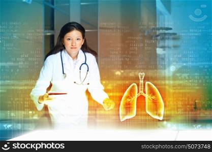 Attractive woman doctor. Image of pretty woman therapist examining virtual image of lungs