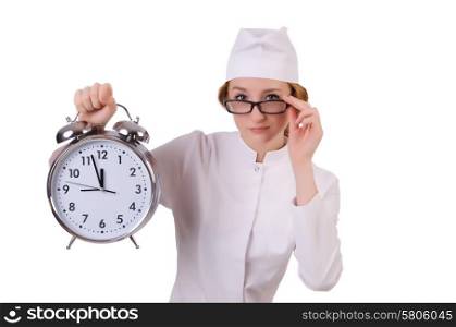 Attractive woman doctor with big clock isolated on white