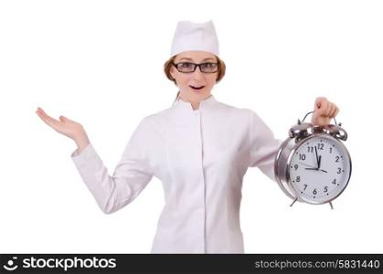 Attractive woman doctor with big clock isolated on white