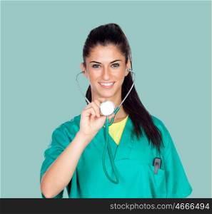 Attractive woman doctor with uniform on a green background