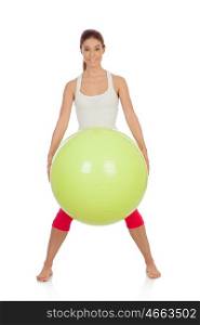 Attractive woman doing pilates with a big green ball isolated