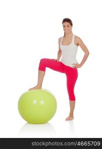 Attractive woman doing pilates with a big green ball isolated