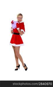 Attractive woman dressed as Mrs. Claus and holding a heart-shaped box