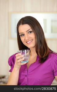 Attractive woman drinking a glass of water