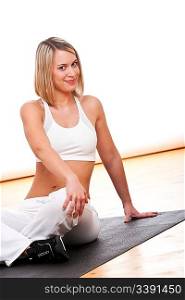 Attractive woman exercising on black mat