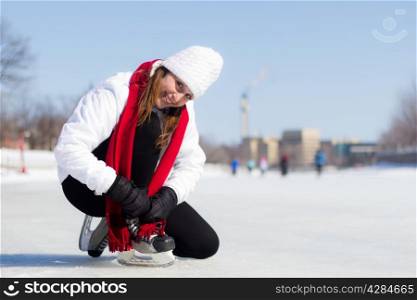 Attractive woman getting ready to ice skate in winter