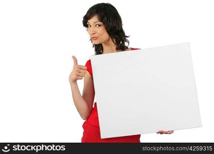 Attractive woman giving the thumbs up to a board left blank for your message