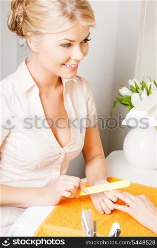 attractive woman having a manicure at the salon