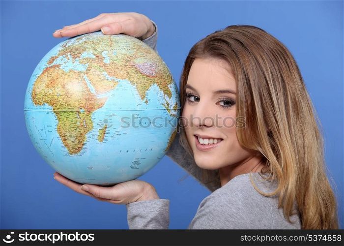 Attractive woman holding a globe