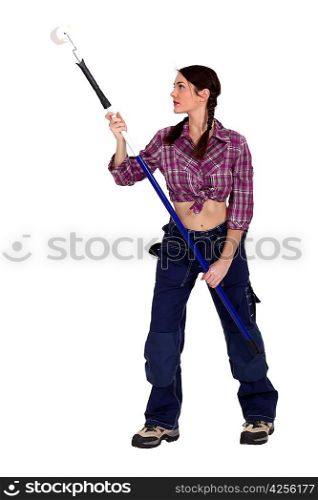 Attractive woman holding a paint roller