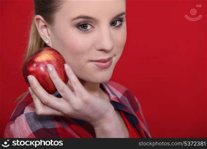 Attractive woman holding a red apple