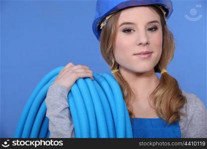 Attractive woman holding corrugated tubing