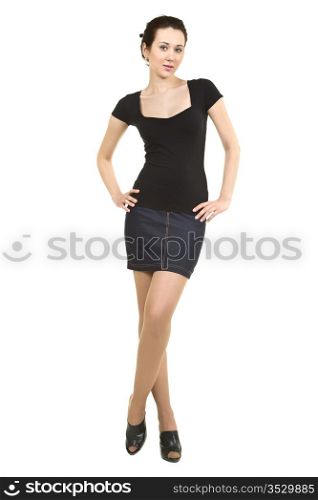 attractive woman in a black shirt and denim skirt. isolated on white