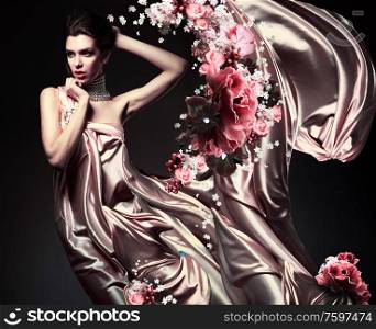 attractive woman in beautiful fabric and flowers