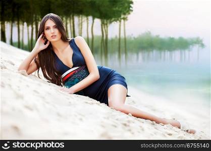 attractive woman in dress on the forest beach