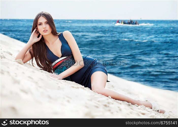 attractive woman in dress on the sea beach