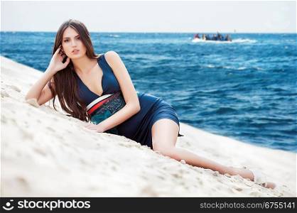attractive woman in dress on the sea beach