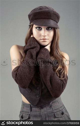 Attractive woman in hat on grey background