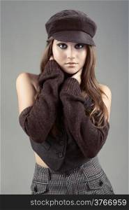 Attractive woman in hat on grey background