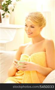 attractive woman in spa salon with a cup