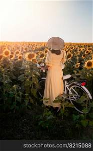 Attractive woman in timeless dress with retro styled bicycle in sunflowers field. Vintage fashion, amazing adventure, countryside activity, healthy lifestyle.