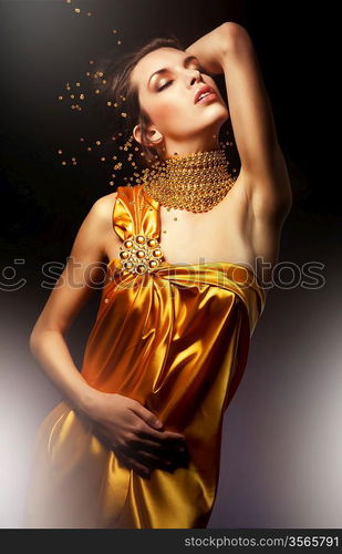 attractive woman in yellow dress with jewelry