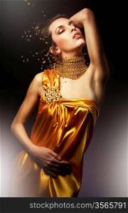 attractive woman in yellow dress with jewelry