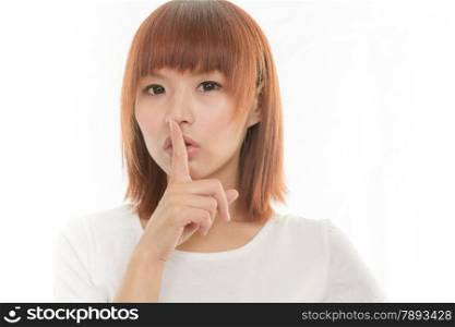 Attractive woman making a keep quiet habd gesture , isolated on white