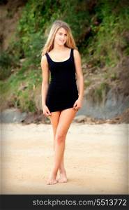 Attractive woman on a beautiful beach with black dress