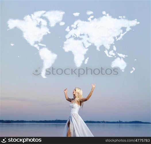 Attractive woman over the cloud world map