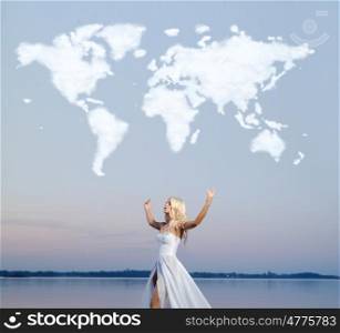 Attractive woman over the cloud world map