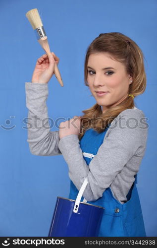 Attractive woman painting a wall