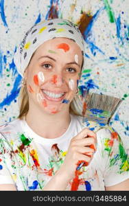 Attractive woman painting the background of many colors