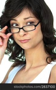 Attractive woman peering over her glasses