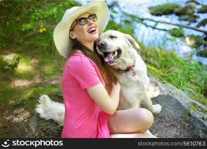 Attractive woman playing with friendly dog