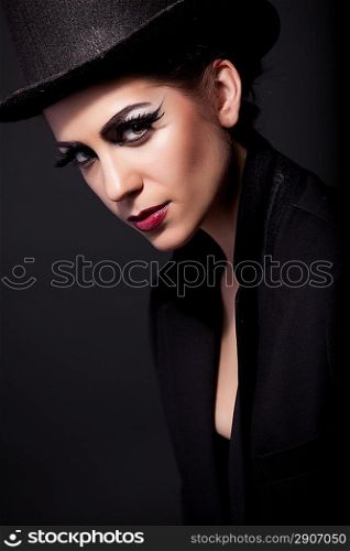 attractive woman portrait in hat with red lips on black background
