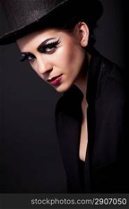 attractive woman portrait in hat with red lips on black background