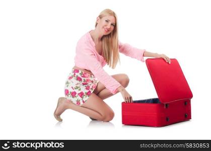 Attractive woman preparing for vacation with suitcase isolated on white
