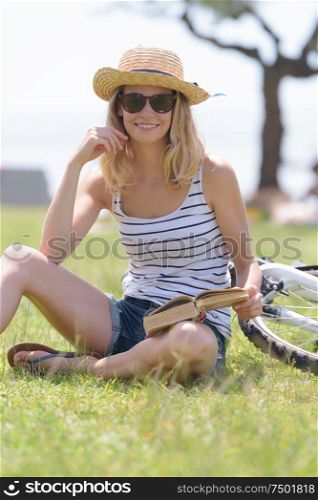 attractive woman reading a book in the park